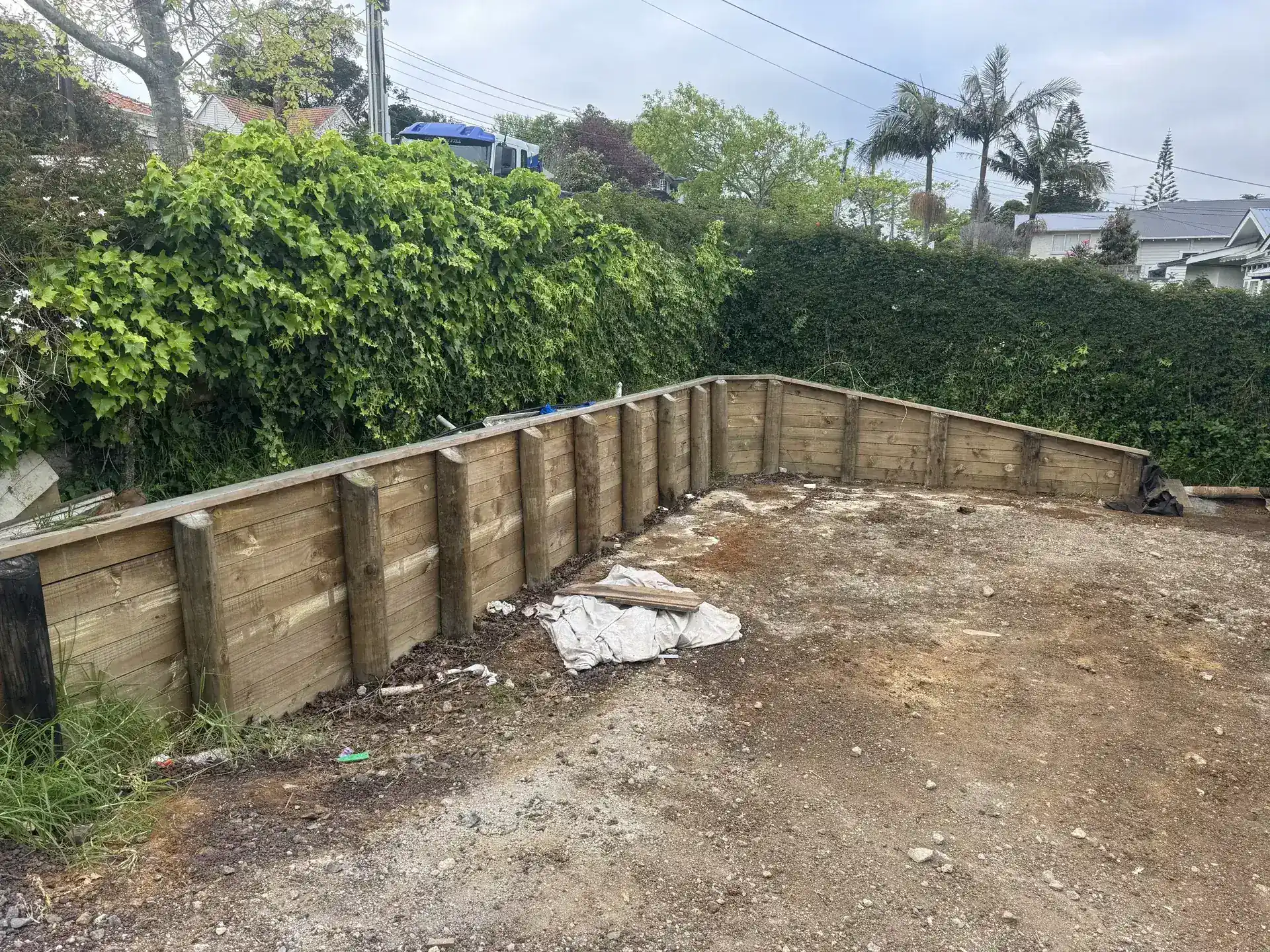 Retaining wall and sloped section typical of Glenfield's hilly North Shore terrain
